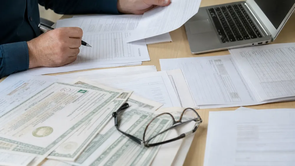 Organic certificate documents and transaction paperwork reviewed at a desk