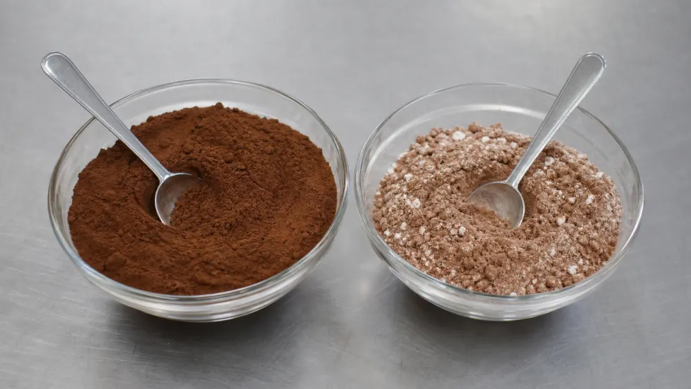 Two bowls comparing pure cocoa powder with adulterated powder blended with pale starch
